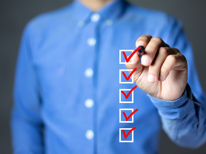 Checklist concept, Businessman checking mark on the check boxes with marker red